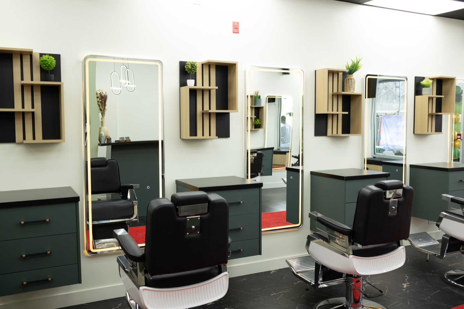 Row of barber chairs and mirrors at Ezz Cutz