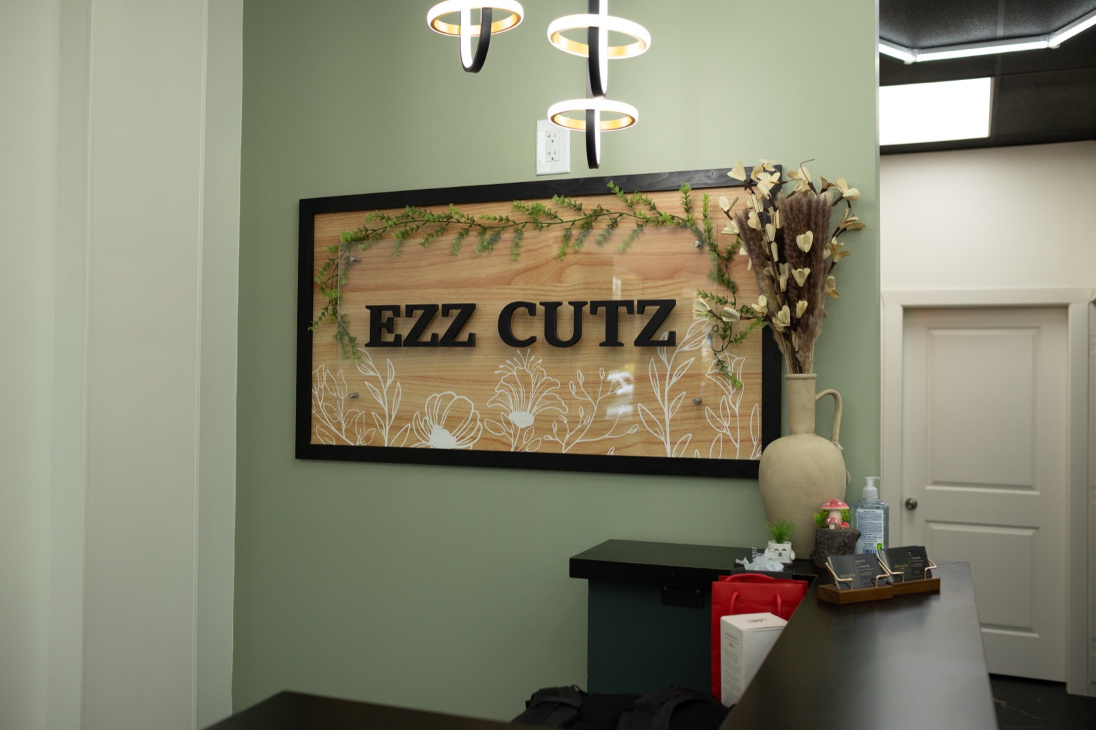 The Ezz Cutz wall sign at the front desk
